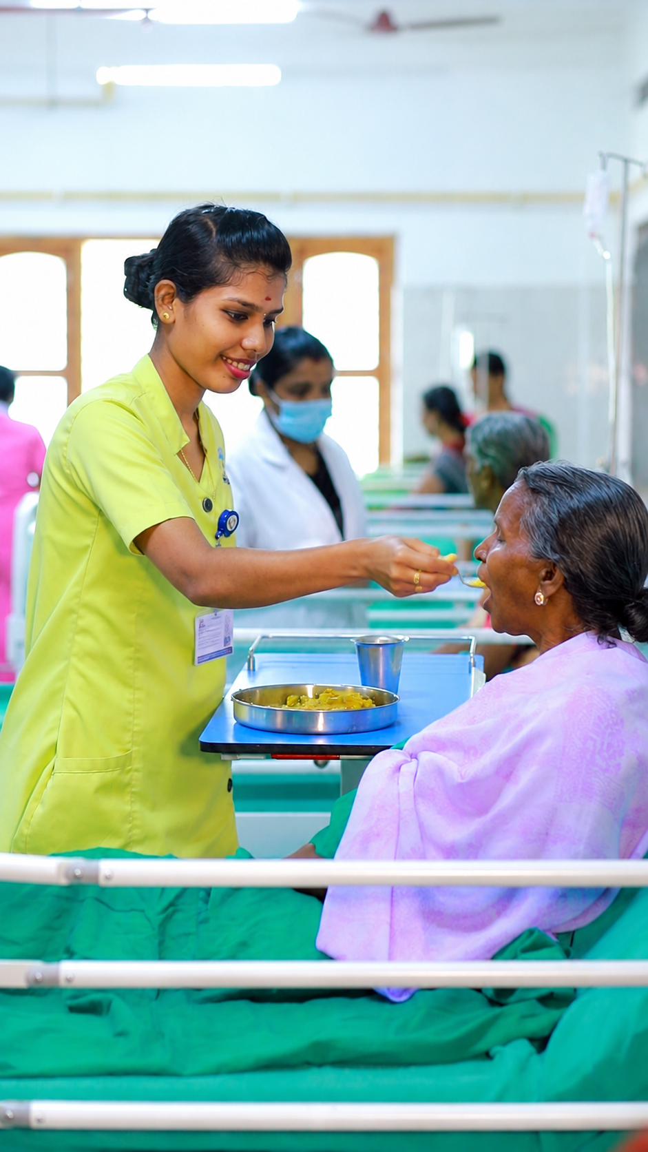 Nutritious Meals with Compassion — nurse feeding a patient